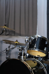 Part of a drum kit with cymbals in a music studio, on stage. Background for photos with live music,...