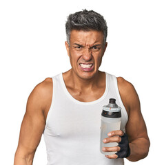 Gym-ready Hispanic man with water bottle screaming very angry and aggressive.