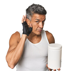 Middle-aged man with gym attire and protein trying to listening a gossip.