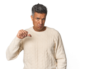 Middle-aged Latino man showing a dislike gesture, thumbs down. Disagreement concept.