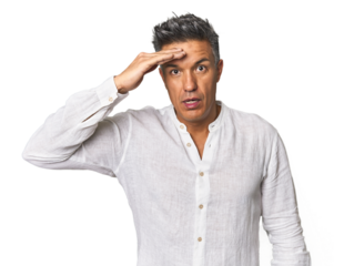 Middle-aged Latino man shouts loud, keeps eyes opened and hands tense.