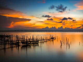 Long exposure shot of a beautiful sunset over Songkhla Lake in Thailand.