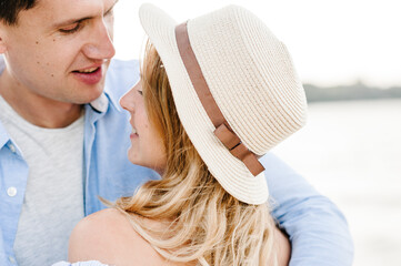 Couple in love looking at each other. Closeup face. Man and woman hugging on sand sea and spending...