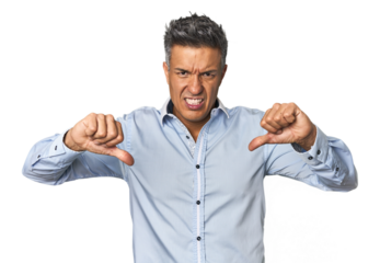 Middle-aged Latino man showing thumb down and expressing dislike.