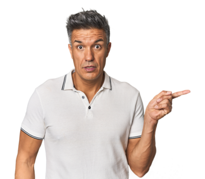 Middle-aged Latino man pointing to the side - Powered by Adobe
