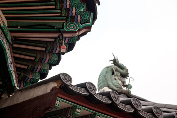 View of the wooden eaves and dragon statue