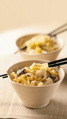 two bowls with wok style chinese noodle sticks