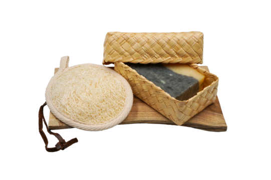 Spa or bathroom set compose of Luffa or loofah scrub and handmade soap in natural weave box on wooden plate in png format