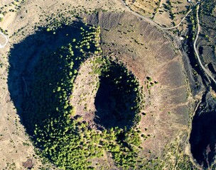 Aerial of the Divlit extinct volcano, mount formantion covered in sparse green vegetation in Turkey - Powered by Adobe