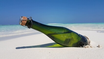 Closeup shot of a bottle on a sandy beach