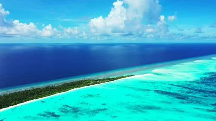 Zelfklevend Fotobehang Aerial view of a small tropical island with a white sandy beach and turquoise water © Wirestock