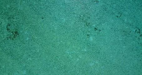 Aerial top view of a turquoise sea on a sunny day