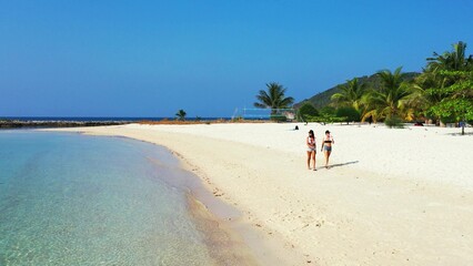 Beautiful shot of two females relaxing at the beach in Koh Samui, Thailand