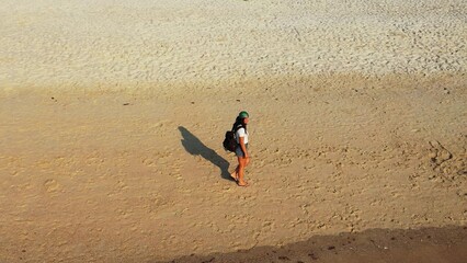 Beautiful shot of a female walking at the beach in Koh Samui, Thailand