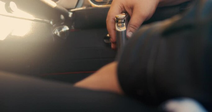 Man Holding Alcohol Flask in Old Vintage Driving Car