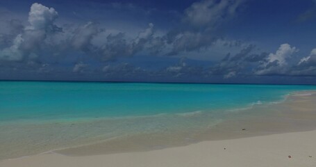 White sandy beach with turquoise water under a blue sky