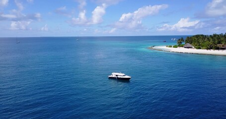 Aerial shot of a ship on a blue calm water