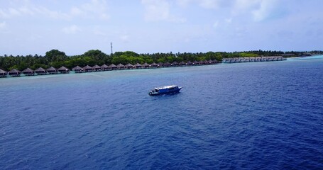 Obraz premium Aerial shot of a ship on a blue calm water