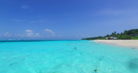 Fototapeta na wymiar Beautiful Turquoise sea water and a small island in the distance