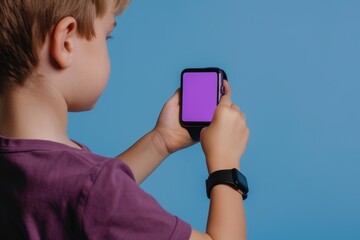 App mockup shoulder view of a young boy holding an smartwatch with an entirely purple screen