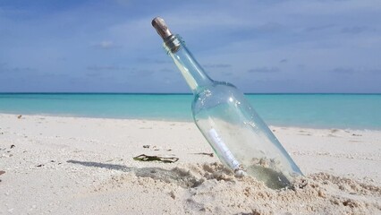 Bottle with a message on the sandy beach