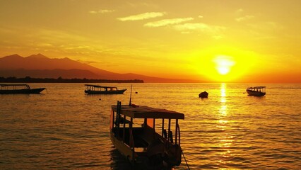 Beautiful landscape of the sunset on the beach and boats in Asia