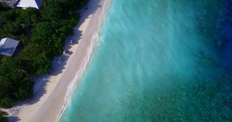 Bird's eye view of the azure water of the ocean and tropical trees in Asia