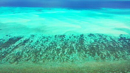 Fototapeta na wymiar Bird's eye view of the azure water of the ocean in Asia