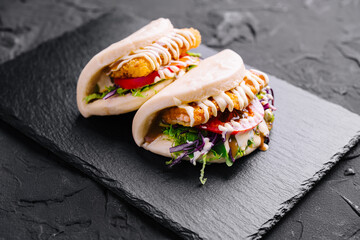 Delectable chicken shawarma pitas on slate background