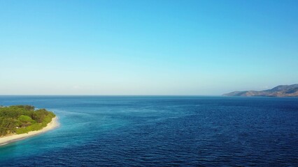 Fototapeta premium Beautiful view of a sea with an island on a sunny day
