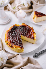 Naklejka premium Traditional basque burnt san sebastian cheesecake slice on elegant table setting