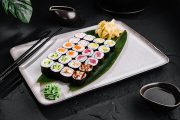 Assorted sushi platter on dark background