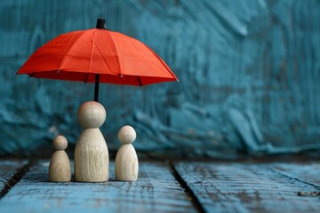 Family protection concept, wooden figures under red umbrella, serene blue, space for copy - obrazy, fototapety, plakaty