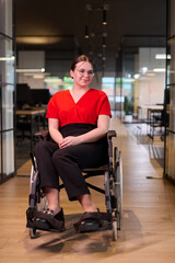 Fototapeta na wymiar A modern young businesswoman in a wheelchair is surrounded by an inclusive workspace with glass-walled offices, embodying determination and innovation in the business world