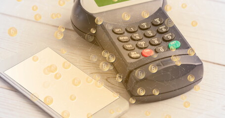 Image of bitcoins over and payment terminal