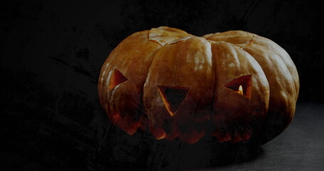 Fototapeta premium Image of jack o lantern halloween pumpkin on black background