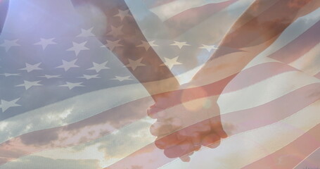 Image of flag of united states of america over couple holding hands