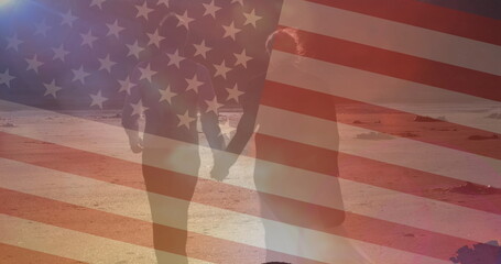 Image of flag of united states of america over couple walking on beach