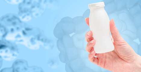 Bottle with probiotic in hand. Product with lactobacilli. Probiotic to improve appetite. Yogurt...