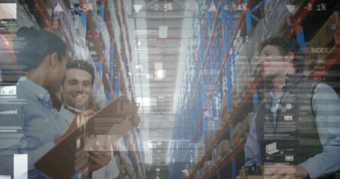 Image of financial graphs over happy diverse female and male warehouse workers clapping hands