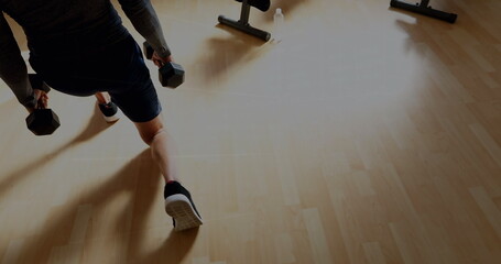 Obraz premium Image of graphs and financial data over midsection of caucasian man exercising with weights