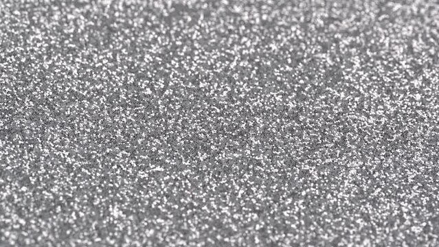 Moving silver sparkle glitter wallpaper. Party background. Shiny background