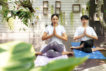 Lifestyle woman and teenage student yoga exercise and pose for healthy life. Two people pose balance body vital zen meditation for workout nature garden at home.  Healthy and sport activity Concept