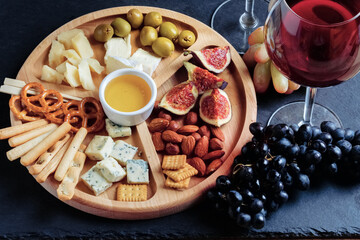 Close up snack plate with glass of wine. Top view.