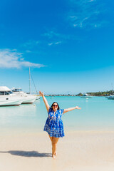 Woman posing in transparent blue ocean. Blue water holidays in Mauritius
