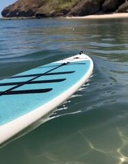 Close-Up of a Paddleboard Paddle in Water. with droplets of water cascading off the edge. The paddle and the water's surface are in sharp focus, showcasing the interaction between the paddle and water