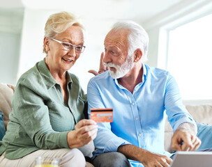 couple credit woman laptop shopping card online senior elderly retirement adult old retired mature senior couple pensioner older active two aged vitality online shopping finace buying bill