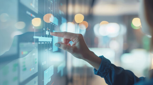 Woman touching virtual screen with project plan or gant chart on digital interface for business management and strategy planning.