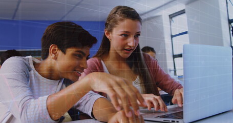 Image of multiracial students studying using laptop in classroom over trading board and graph