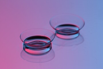 Pair of contact lenses on mirror surface, closeup
